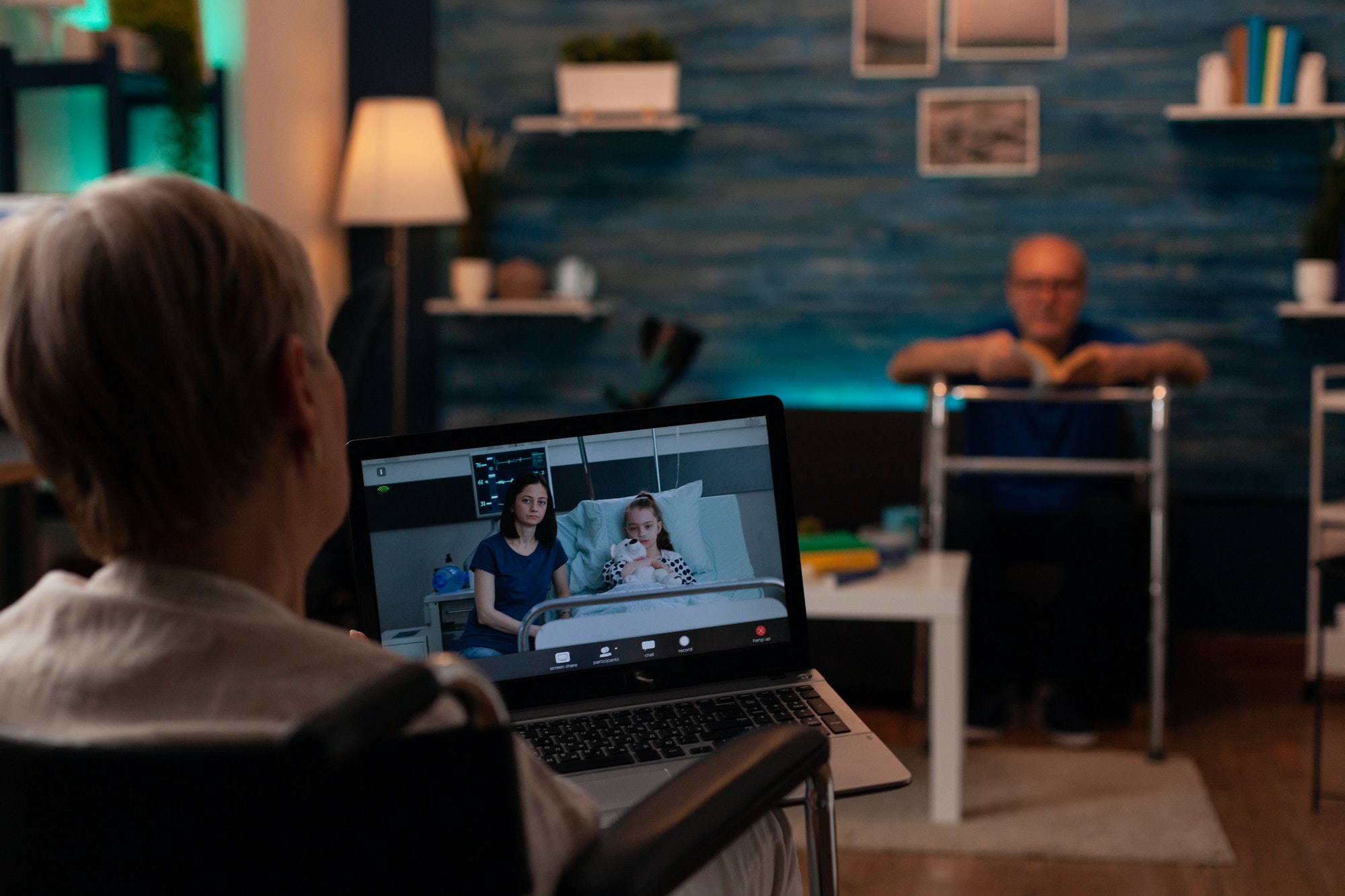 Aged woman with handicap using video call with laptop